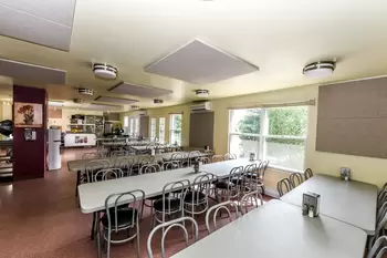 Cafeteria with long tables and chairs